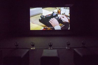 Ho Tzu Nyen, The Name (2015–2017). Video (single-channel HD projection, 16:9, colour, six-channel sound), 16 books. 16 min, 51 sec (English); 16 min, 52 sec (Chinese). Collection Singapore Art Museum. Exhibition view: Time & the Tiger, Singapore Art Museum (24 November 2023–3 March 2024).
