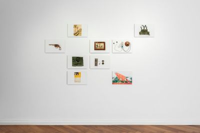 Drawings of objects and landscape on A5 pages on the gallery wall. 