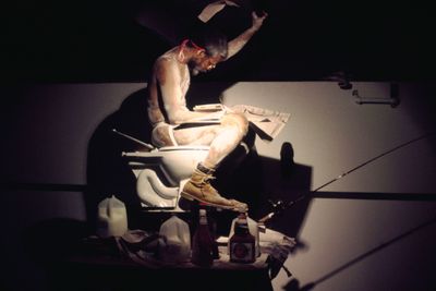 Pope.L, Eating the Wall Street Journal (3rd version) (2000). Performance view: MoMA, New York.