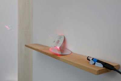Yan Jun, TOOL: A Physical Model (2018). Laser pointer, cracked CD. Exhibition view: It Always Sounds Somewhere: Sounding Sound Practice in Chinese Mainland and Hong Kong Since the 1990s, Inside-Out Art Museum, Beijing (22 February–1 June 2025).