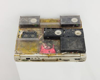 Lee 'Scratch' Perry, Laptop (Black Ark) (c. 2009). Collage and tape reels on laptop. 28 x 15 x 8 cm.