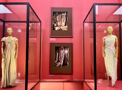 Left to right: Dior, silk-lame evening dress (1956); Tarun Tahiliani, crinkle-tulle drape dress (2020). Exhibition view: India in Fashion: The Impact of Indian Dress and Textiles on the Fashionable Imagination, Nita Mukesh Ambani Cultural Centre, Mumbai (3 April–4 June 2023). Photo: Stephanie Bailey.