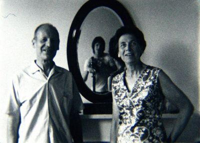 Guy Sherwin, Portrait with Parents #2 (1975). Installation for 16 mm projector, mirror, paint, 3 minute film loop.