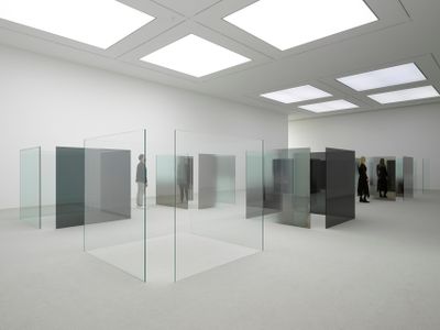 Larry Bell, 6 x 6 An Improvisation (1989–2014). Clear glass, grey glass, and glass coated with Inconel (Nickel/chrome alloy). 40 panels. Each 182.9 x 182.9 x 1.3 cm. Exhibition view: LarryBell, Smoke On The Bottom, White Cube Bermondsey (28 April–18 June 2017). © White Cube. © Larry Bell. Photo: Ben Westoby.