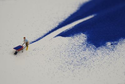 Liliana Porter, Forced Labor (blue sand) II (2008) (detail), part of the series ‘Forced Labor’. Figurine and blue sand on shelf. 25.4 x 109.22 x 7.62 cm. Courtesy the artist.