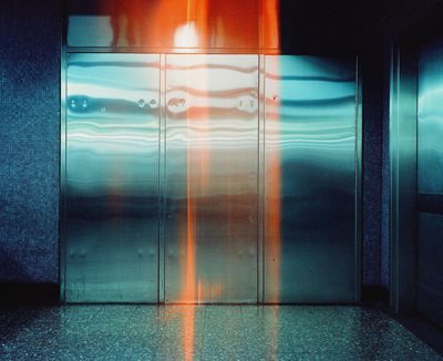 A metallic door in Causeway Bay station in Hong Kong features a glitch of yellow light spilling down its centre.