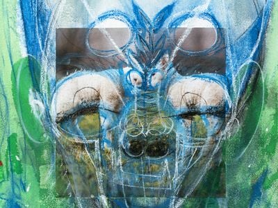 An alien-like figure brusquely outlined in shades of blue, green, and white features photographs of two rams as eyes.