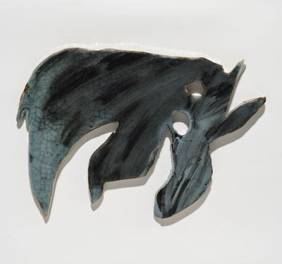 An abstract ceramic piece by Manuel Mathieu glazed blue and black.
