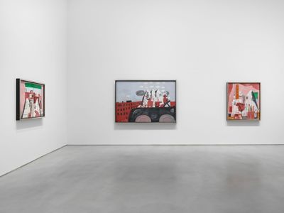 Three canvases by Philip Guston feature klansmen engaged in everyday activities, including studio painting and riding a car. The paintings line two walls of a bright, white gallery space.