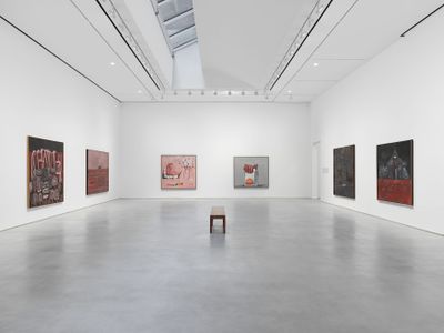 Six large canvases by Philip Guston line three walls in a bright, white exhibition space.