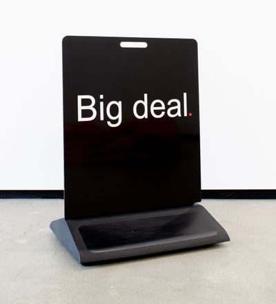 Artist Elisabeth Pointon’s Black footpath sign with bold white letters saying ‘Big deal’ and full-stop in red