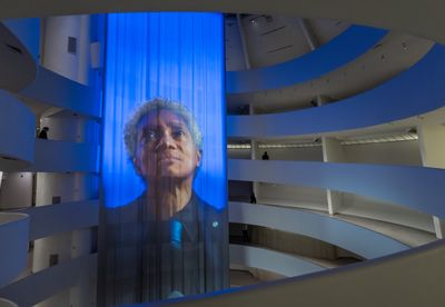 Curtain projection of Wu Tsang's artwork portraying Glenn-Copeland singing inside the Guggenheim Museum