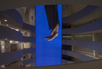 Inside the Guggenheim Museum hangs a long curtain projection of Wu Tsang's artwork portraying Glenn-Copeland's hand