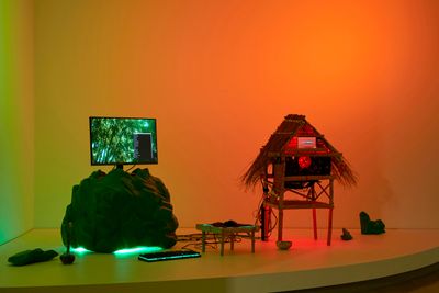 Tiyan Baker, Personal computer: ramin ntaangan (2022–23). Computer parts, computer monitors, screensaver video, bamboo, wood, palm and coconut leaf, plastic twine, heirloom machete, sunflower seeds, LED lighting, foam, spray paint, lucky bamboo. Exhibition view: Primavera 2023: Young Australian Artists, Museum of Contemporary Art Australia, Sydney (8 September 2023–4 February 2024).