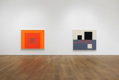 Left to right: Peter Halley, Day-Glo Prison (1982). Fluorescent acrylic and Roll-a-Tex on canvas; Two Cells with Conduit and Underground Chamber (1983). Acrylic, fluorescent acrylic, and Roll-a-tex on unprimed canvas. Two attached panels. Exhibition view: Conduits: Paintings from the 1980s, Mudam Luxembourg (31 March–15 October 2023). © Photo: Mareike Tocha/Mudam Luxembourg.
