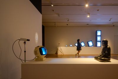 Nam June Paik, TV Buddha (1974). Closed-circuit video installation with wooden sculpture, monitor and video camera, video, single channel, 4:3 format, live feed. Collection of Stedelijk Museum Amsterdam. Installation view at National Gallery Singapore.
