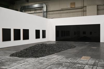 Installation view of: Pile of Coal (1963), sculpture with no specific dimensions; Goudrons (1963), tar on canvas, 150 x 130 cm; and Black Mirror (1966), black paint on plexiglass, dimensions site-specific.