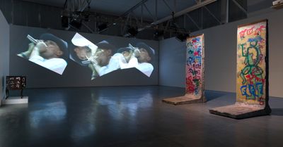 Left: Nam June Paik, Beuys Projection (1990). Single-channel video (colour, sound), media player, and video distribution amplifier. Right: Nam June Paik, Berlin Wall (2005). Acrylic paint on graffitied segment of the Berlin Wall. Installation view.