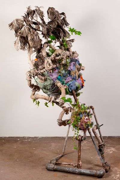Hannah Chalew, Flotant Year (2020). Metal, sugarcane, disposable plastic waste, soil, living plants, iron oak gall ink, ink made from shells. 76 x 48 x 34" inches.