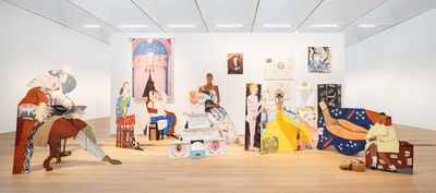 Lubaina Himid, A Fashionable Marriage (1986). Wood, rubber gloves, acrylic paint, newspaper, glue, plastic, paper, tissue, foil, wicker basket, books, cardboard, canvas, metal, sound. Overall dimensions variable. © Lubaina Himid.