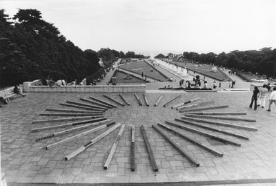 Susumu Koshimizu, From Surface to Surface (Wooden Logs Placed in a Radial Pattern on the Ground) (1972). Installed at 3rd Contemporary Sculpture Exhibition, Suma Rikyu Park, Kobe, Japan, 1972 © Estate of Shigeo Anzaï,