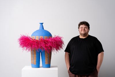 Alfred Lowe with his MA Art Prize-winning sculpture All dressed up I (2024). Hand built stoneware with sgraffito and raffia. 870 x 910 x 830mm.