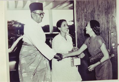 Georgette Chen welcoming Tunku Abdul Rahman and his wife Tun Sharifah Rodziah Barakbah to her solo exhibition at the British Council Hall in Kuala Lumpur, 1956. Gift of Lee Foundation. Collection of National Gallery Singapore Library & Archive.