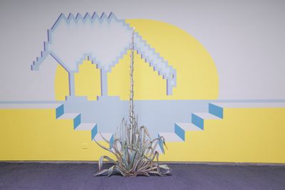 Foreground: Claudia Martínez Garay, Agave Americana About to Bloom (2020). Sublimated print on aluminium, steel stand. 235 x 115 cm; background: Mural (for llama) (2020). Wall painting. Dimensions variable. Exhibition view: Claudia Martínez Garay and Miriam Cahn, Ten Thousand Things, Sifang Art Museum, Nanjing (8 November 2020–23 May 2021).