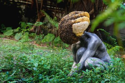 Pierre Huyghe, Exomind (Deep Water) (2017). Concrete cast with wax hive, bee colony. Figure: 72 × 60 × 79 cm. Beehive dimensions vary. Exhibition view: 12th Taipei Biennial, You and I Don't Live on the Same Planet, Taipei Fine Arts Museum, Taipei (21 November 2020–14 March 2021).
