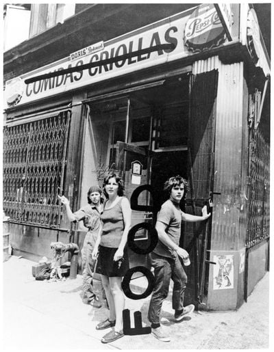 Tina Girouard, left, with Carol Goodden and Gordon Matta-Clark in front of Food, their artist-run restaurant at the corner of Prince and Wooster Streets in SoHo in 1971. Credit: Richard Landry, alteration by Gordon Matta-Clark, via David Zwirner, New York.