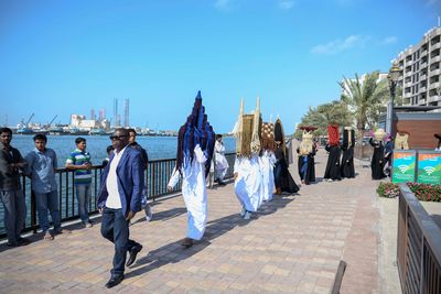 Meschac Gaba, Perruques Architectures Émirats Arabes Unis (2019). Processional performance. Performance view: Sharjah Biennial 14: Leaving the Echo Chamber (7 March–10 June 2019). Courtesy Sharjah Art Foundation.
