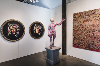 Yinka Shonibare, Medusa West (2015) and Medusa East (2015). Digital chromogenic print, bespoke wood frame. 114 cm diameter each; Pan (2018). Unique fibreglass sculpture, hand-painted with Dutch wax pattern, bespoke hand-coloured globe, gold leaf and steel baseplate. 143.8 x 84.8 x 59.7 cm; Elias Sime, Tightrope, non-essential speed (2017). 72.4 x 402.6 cm (left to right). Exhibition view: James Cohan Gallery, 1-54 Contemporary African Art Fair, New York (4–6 May 2018). Courtesy 1-54 Contemporary African Art Fair. Photo: © Katrina Sorrentino.