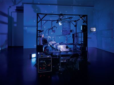 Janet Cardiff and George Bures Miller, The Killing Machine (2007). Pneumatics, robotics, electromagnetic beaters, dentist chair, electric guitar, CRT monitors, computer, various control systems, lights, and sound. Approx 5 min. 118 x 157 x 98 cm. The Museum of Modern Art, New York. Gift of the Julia Stoschek Foundation, Düsseldorf, and the Dunn Bequest. © 2019 Janet Cardiff and George Bures Miller. Courtesy the artists and Luhring Augustine, New York. Photo: Seber Ugarte & Lorena López. 