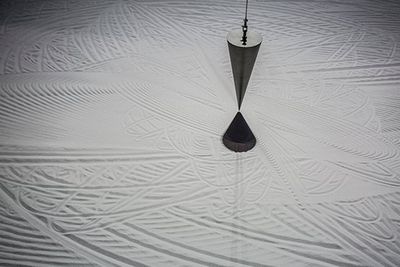 Marjolijn Dijkman, Lunar Station (2015). Steel pendulum, sand, table, video, found objects. Exhibition view: 11th Shanghai Biennale, Power Station of Art (12 November 2016—12 March 2017).