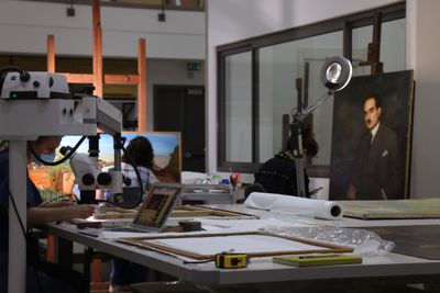 Sursock Museum workers are photographed in the lab restoring paintings.