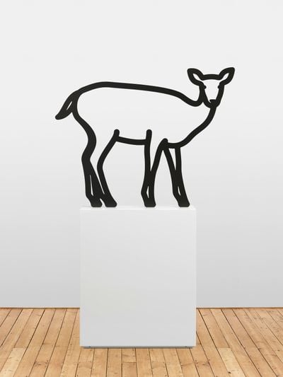 Artist Julian Opie depicts an outline image of a deer made from thin strips of metal painted in black, standing on top of a white plinth