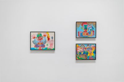 Three paintings by Moki Cherry are placed upon a white exhibition wall, their figures and forms all rendered in effervescent colours and fluid forms.