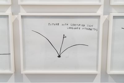 A small drawing in a frame captures a golf put hole with two lines and a flagpole coming out of it. At the top-right hand corner of the drawing, a hand-drawn phrase in capital letters reads 'Future with certified sign language interpreters'. 