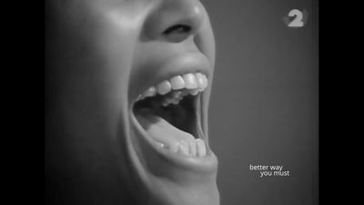 The mouth of Nina Simone is captured in black and white in a single-screen video. The words 'Better You Must' are written to the right of her mouth, as if hovering mid-air.