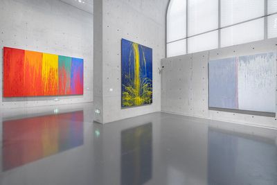 Abstract drip paintings hanging in exhibition space