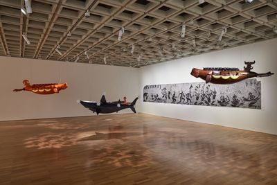 Alick Tipoti, Dhangal Madhubal and Baydham (both 2021). Fibreglass resin, rope, beads, acrylic. Installation dimensions variable. Courtesy the artist. Girelal (2011). Single-block vinyl cut printed in black ink on paper. 120 x 825 cm. Cairns Art Gallery, Queensland, donated through the Australian Government's Cultural Gifts. Program by Editions Tremblay, 2012. Courtesy the artist and Cairns Art Gallery. Exhibition view: The National 2021: New Australian Art, Art Gallery of New South Wales, Sydney (26 March–5 September 2021). Photo: AGNSW, Felicity Jenkins.
