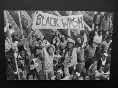 Artwork depicting black people protesting holding a sign saying Black Wash, from the exhibition War Inna Babylon at Institute of Contemporary Art