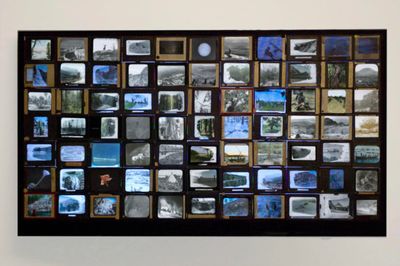 Dana Levy, History Lessons (2022). 50-inch L.E.D. screen with 77 antique magic lantern slides mounted on top; single-channel video.