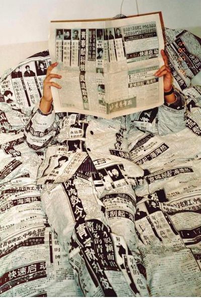 Wang Youshen, Newspaper – Reading (1993). Performance. Photograph. 185 x 127 cm, 70 x 48 cm.