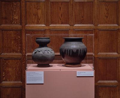 Left to right: Unknown, Dowry, water or palm wine vessel (1900–1970). Stoneware; Unknown, Pot (1900–1970). Stoneware. Exhibition view: Body Vessel Clay: Black Women, Ceramics & Contemporary Art, Two Temple Place, London (29 January–24 April 2022). © Two Temple Place.