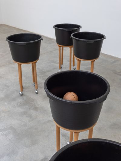 Chung Seoyoung, Road (1993). 7 pieces: wood, plastic bucket, casters, paint. Dimensions (each): 56 x 56 x 97 cm.