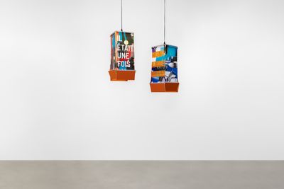 Rirkrit Tiravanija and Rafael Domenech, Meditating in the eye of the storm 2 and 3 (2023). Printed paper, wood, fabric, electric wire. 55 x 22 x 22 cm (each).