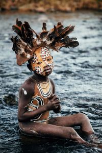 Suri Boy in River, Omo Valey, Ethiopia by Andrew Eldon contemporary artwork photography, print
