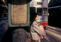 Woman at tram stop, Central, Hong Kong by Greg Girard contemporary artwork photography, print