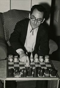 Man Ray with one of his designs for Chessmen by Man Ray contemporary artwork photography